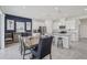 Open concept kitchen and dining area featuring white cabinetry and stainless steel appliances at 10580 Gliding Eagle Way, Land O Lakes, FL 34638