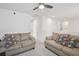 Upstairs living room featuring two comfortable sofas with decorative pillows and a ceiling fan at 10580 Gliding Eagle Way, Land O Lakes, FL 34638