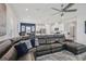 Spacious living room featuring a large sectional sofa, ceiling fan and an open layout at 10580 Gliding Eagle Way, Land O Lakes, FL 34638