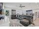 Open-concept living area with a sectional sofa, flowing into the dining and kitchen spaces at 10580 Gliding Eagle Way, Land O Lakes, FL 34638