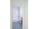 Bathroom with stylish blue patterned tile flooring, white walls, and a shower-tub combo at 10605 Marsanne Pl, Riverview, FL 33578