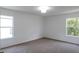 Neutral-toned bedroom with two windows and wall-to-wall carpeting and neutral paint at 10605 Marsanne Pl, Riverview, FL 33578