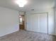 Light and airy bedroom with a large closet and doorway to the rest of the house, as well as plush carpeting at 10605 Marsanne Pl, Riverview, FL 33578
