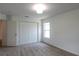 Neutral carpeted bedroom with a closet, ceiling light, and view of the backyard through the window at 10605 Marsanne Pl, Riverview, FL 33578