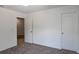 Neutral carpeted bedroom featuring neutral walls, a door and view to another room, and a closet at 10605 Marsanne Pl, Riverview, FL 33578