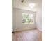 Bedroom featuring a window with natural light, wood-look floors, neutral paint, and modern lighting at 10605 Marsanne Pl, Riverview, FL 33578