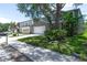 Street view showing the property's facade, two-car garage, and adjacent homes in the neighborhood at 10605 Marsanne Pl, Riverview, FL 33578