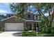 Charming two-story home features a well-maintained front yard and a welcoming turquoise front door at 10605 Marsanne Pl, Riverview, FL 33578