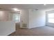Upstairs hallway featuring neutral carpet, white walls, and plenty of natural light from a window at 10605 Marsanne Pl, Riverview, FL 33578