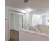 Upstairs hallway with neutral carpet, and an open doorway that leads to another room at 10605 Marsanne Pl, Riverview, FL 33578