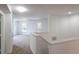 Upstairs hallway featuring neutral carpet, white walls, and natural light from multiple windows at 10605 Marsanne Pl, Riverview, FL 33578
