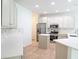 Spacious kitchen offers stainless steel appliances, tile flooring, recessed lighting, a center island, and plentiful counter space at 10605 Marsanne Pl, Riverview, FL 33578