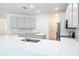 Modern kitchen with stainless appliances, white countertops, undermount sink, neutral cabinets, and stylish subway tile backsplash at 10605 Marsanne Pl, Riverview, FL 33578