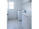 Bright laundry room with modern washer and dryer and neutral-colored flooring at 10605 Marsanne Pl, Riverview, FL 33578