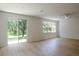 Bright living room with hardwood floors and sliding glass doors to the yard at 10605 Marsanne Pl, Riverview, FL 33578