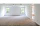 Large main bedroom features neutral carpet, white walls, ceiling fan and natural light from multiple windows at 10605 Marsanne Pl, Riverview, FL 33578