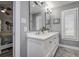 Well-lit bathroom showcases a double vanity with white cabinets and countertops and stylish lighting and mirrors at 1117 S Florida Ave, Tarpon Springs, FL 34689