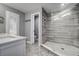Modern bathroom boasts a dual shower head, light gray tiling, white countertops and marbled tile floors at 1117 S Florida Ave, Tarpon Springs, FL 34689