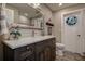 Bathroom with dark wood vanity and granite countertops with a separate toilet area featuring a stained glass window at 1117 S Florida Ave, Tarpon Springs, FL 34689