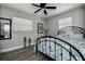 Well lit bedroom features a black metal bed frame, ceiling fan, and wood-look tile floor at 1117 S Florida Ave, Tarpon Springs, FL 34689