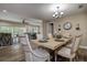 Formal dining room features a rustic wood table, chandelier, and easy access to the living area at 1117 S Florida Ave, Tarpon Springs, FL 34689