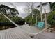 Relaxing waterfront scene with a hammock on the dock, providing a peaceful retreat by the water at 1117 S Florida Ave, Tarpon Springs, FL 34689