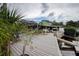 Expansive outdoor living space featuring an incredible dock and waterfront with tropical landscaping at 1117 S Florida Ave, Tarpon Springs, FL 34689