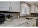 Kitchen counter with granite countertops, tile backsplash, and stainless faucet at 1117 S Florida Ave, Tarpon Springs, FL 34689