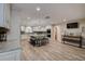 Open kitchen with island, stainless appliances, and wood tile flooring at 1117 S Florida Ave, Tarpon Springs, FL 34689