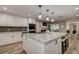 Open kitchen with large island, stainless appliances, and wood tile flooring at 1117 S Florida Ave, Tarpon Springs, FL 34689