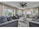 Bright and open living room with neutral decor, large windows, and a ceiling fan at 1117 S Florida Ave, Tarpon Springs, FL 34689