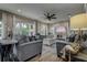 Comfortable living room features plush seating, a ceiling fan, and large windows for natural light at 1117 S Florida Ave, Tarpon Springs, FL 34689