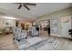 Cozy living room with stylish seating, a decorative rug, and open access to the dining area at 1117 S Florida Ave, Tarpon Springs, FL 34689