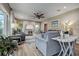 Open living room featuring neutral color palette, large windows, and a sliding door to the outside at 1117 S Florida Ave, Tarpon Springs, FL 34689