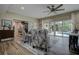 Bright living room with plush chairs, sliding glass doors to the pool, and wood-look tile flooring at 1117 S Florida Ave, Tarpon Springs, FL 34689