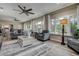 Bright living room with multiple seating areas, large windows, and views of the outdoors at 1117 S Florida Ave, Tarpon Springs, FL 34689