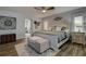 Spacious bedroom offers wood look tile floors, a comfortable area rug and a bright ceiling fan with lighting at 1117 S Florida Ave, Tarpon Springs, FL 34689