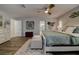 Spacious main bedroom showcases wood look tile floors, an area rug and a bright ceiling fan with lighting at 1117 S Florida Ave, Tarpon Springs, FL 34689