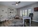 Comfortable home office featuring plantation shutters, wood look floors and a ceiling fan at 1117 S Florida Ave, Tarpon Springs, FL 34689