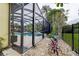Screened in patio with a pool and landscaping at 1117 S Florida Ave, Tarpon Springs, FL 34689