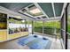 Bright sunroom with yoga mats, cushions, shelving, and a serene backyard view at 1117 S Florida Ave, Tarpon Springs, FL 34689
