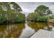 Scenic canal view surrounded by lush greenery, providing a tranquil and private setting at 1117 S Florida Ave, Tarpon Springs, FL 34689