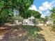 Large backyard featuring mature trees and green grass at 1135 17Th Sw Ave, Largo, FL 33778