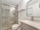Modern bathroom featuring a glass-enclosed shower and updated fixtures at 1135 17Th Sw Ave, Largo, FL 33778