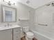 Well-lit bathroom with a shower/tub combo and gray cabinets at 1135 17Th Sw Ave, Largo, FL 33778