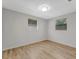 Clean bedroom featuring wood floors and two windows with wooded views at 1135 17Th Sw Ave, Largo, FL 33778