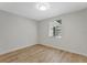 Cozy bedroom featuring wood floors and a window with wooded views at 1135 17Th Sw Ave, Largo, FL 33778