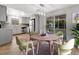 Bright dining area with modern light fixture, access to kitchen and glass enclosed porch at 1135 17Th Sw Ave, Largo, FL 33778