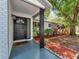 Inviting front porch boasts stylish tile flooring, and decorative landscaping at 1135 17Th Sw Ave, Largo, FL 33778