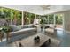 Bright glass enclosed porch filled with sunlight and plenty of seating at 1135 17Th Sw Ave, Largo, FL 33778